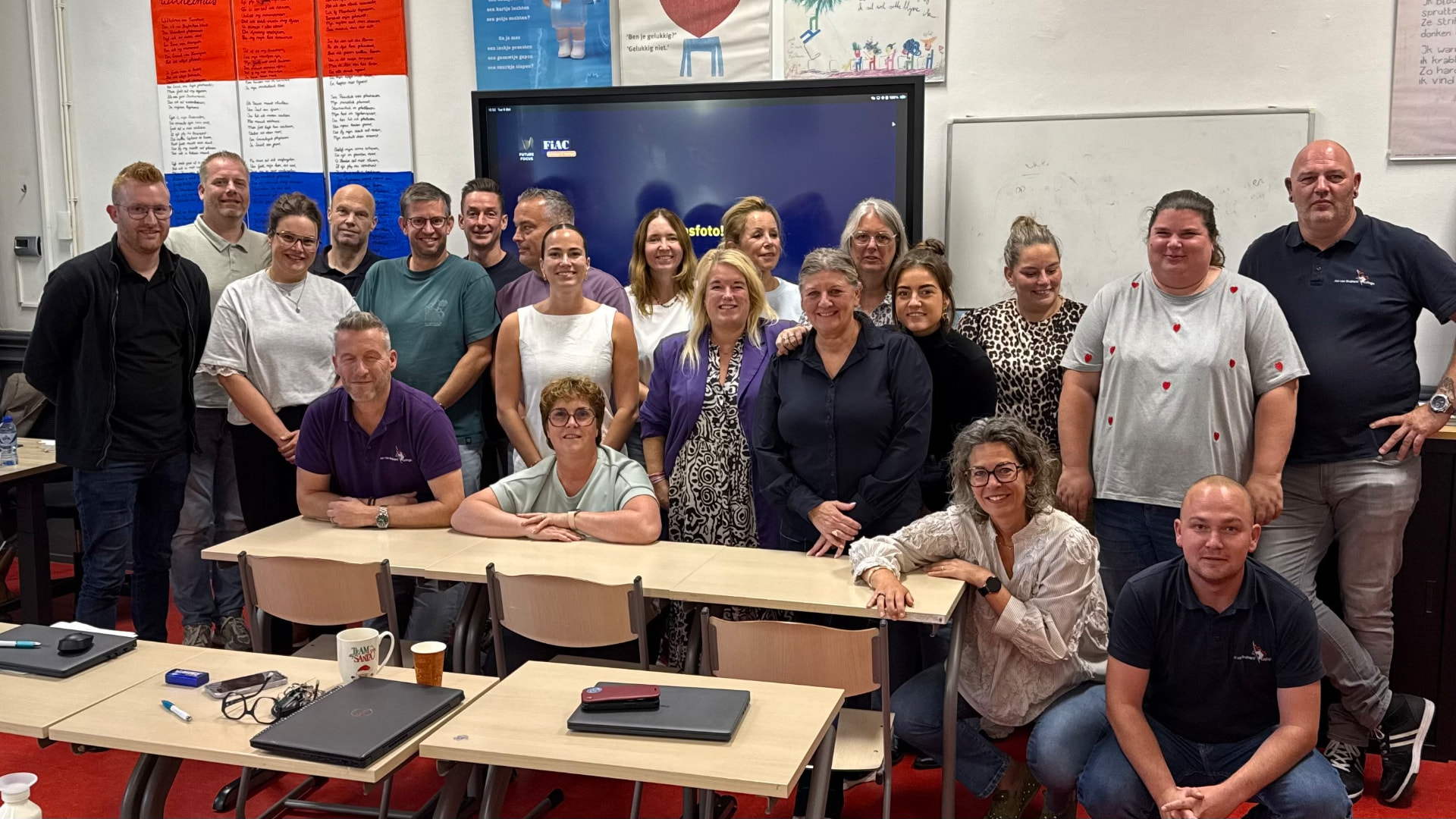 Large group photo of AI training participants in the classroom